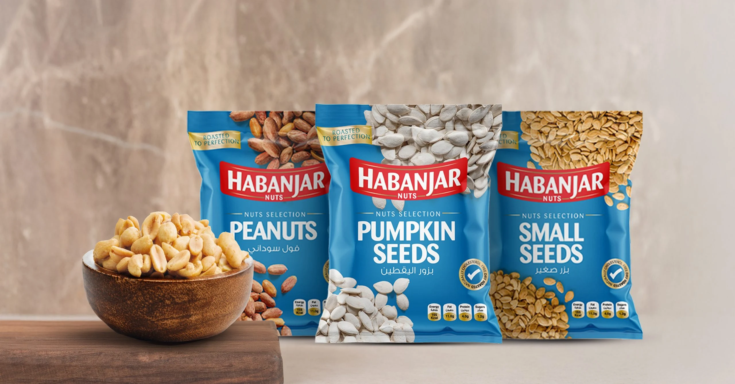Habanjar Peanuts, Pumpkin Seeds and Small Seeds pouches beside a bowl of peanuts
